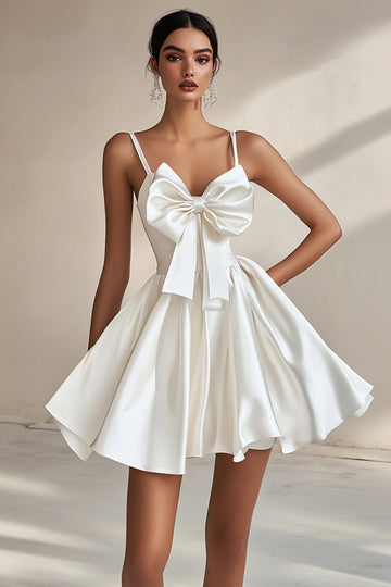 Une ligne robe de graduation blanche à bretelles spaghetti avec nœuds